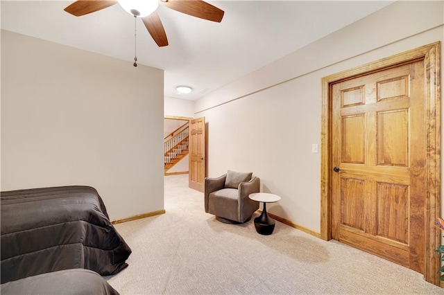 living room with ceiling fan and light colored carpet