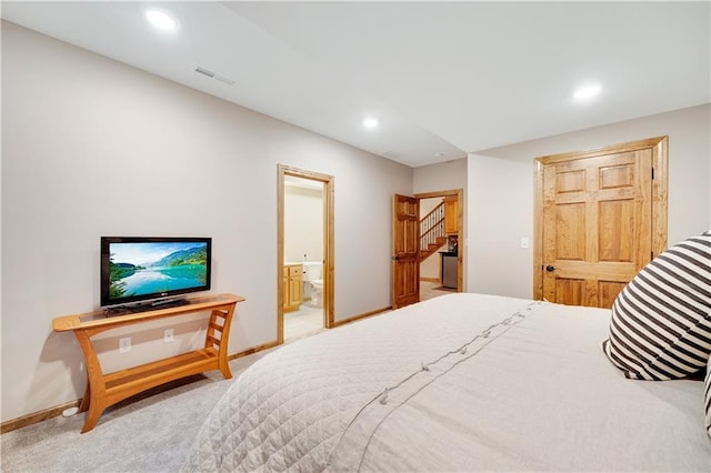 bedroom featuring carpet flooring and connected bathroom