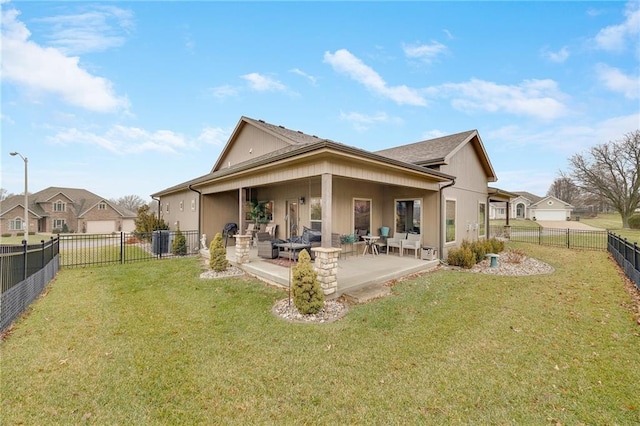 back of house featuring a patio area and a lawn