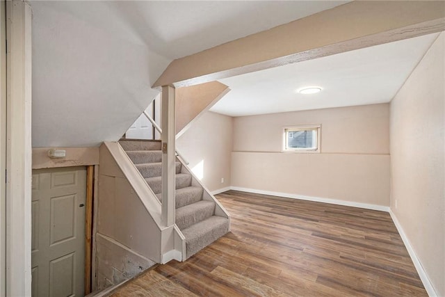 interior space with stairway, baseboards, and wood finished floors