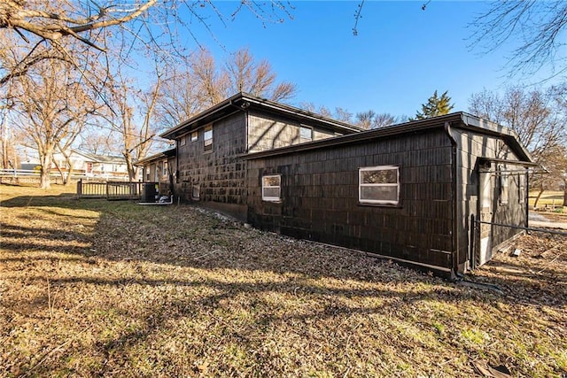 view of side of home featuring a yard