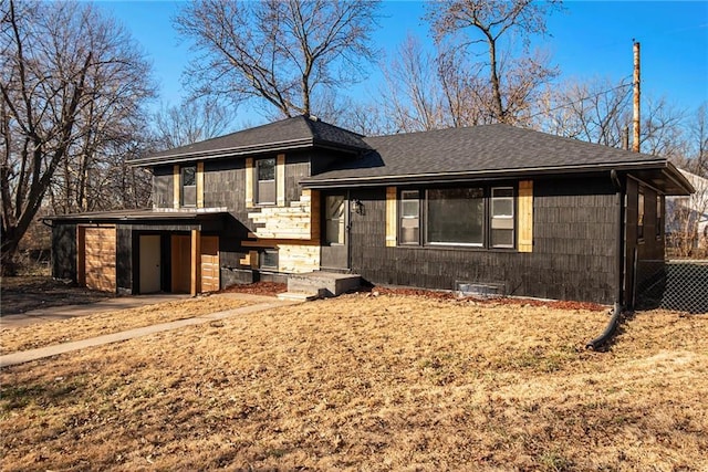 view of front facade featuring roof with shingles