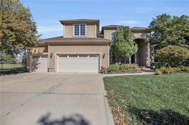 view of front of home featuring a front yard and a garage