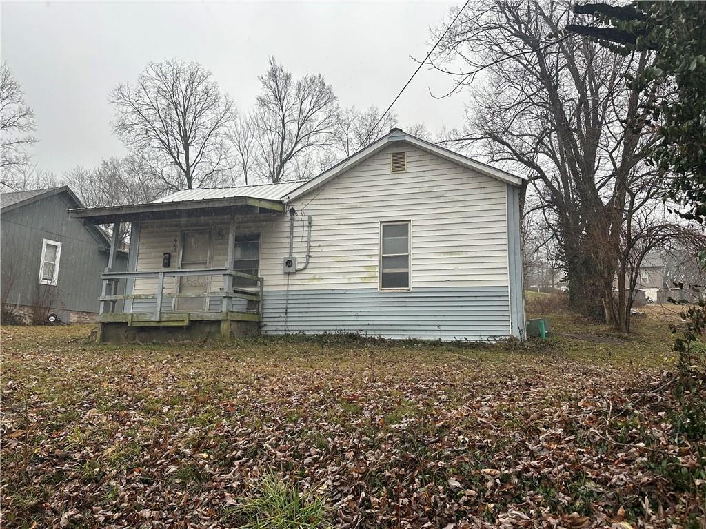 back of property featuring a porch