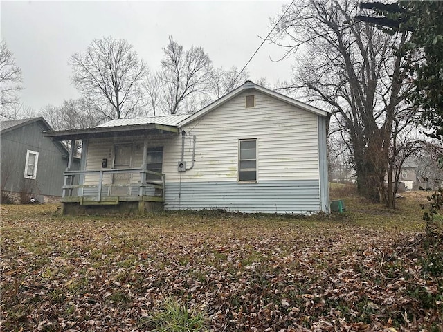 back of property featuring a porch