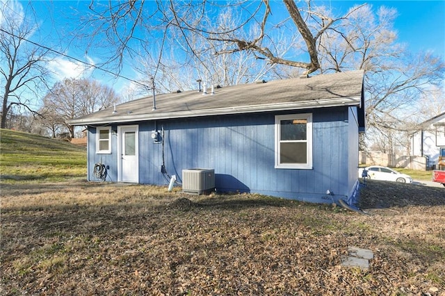 rear view of property featuring central air condition unit