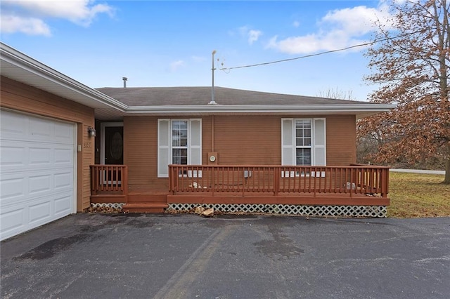 view of front of house featuring a garage and a wooden deck