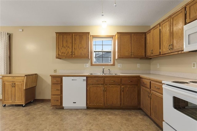 kitchen featuring sink and white appliances