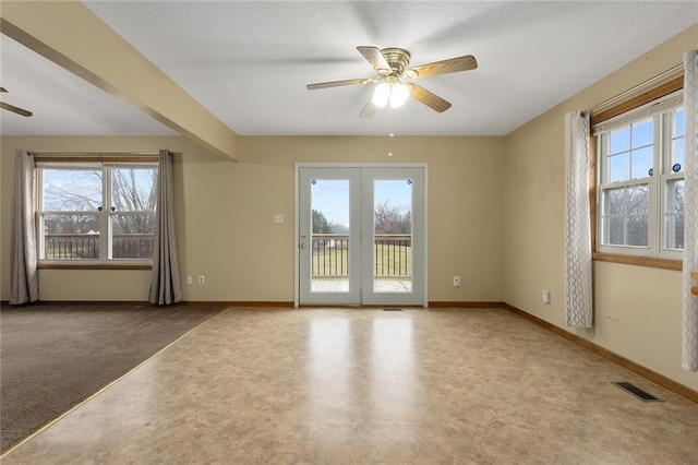 carpeted spare room with ceiling fan