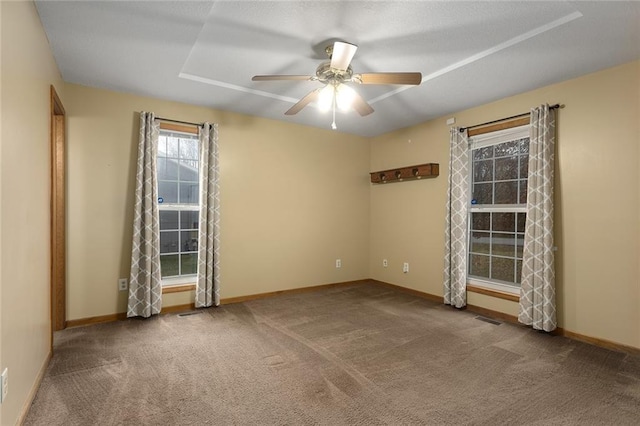 carpeted spare room featuring ceiling fan