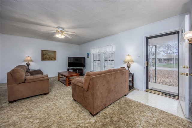 living room featuring ceiling fan, light colored carpet, and a textured ceiling