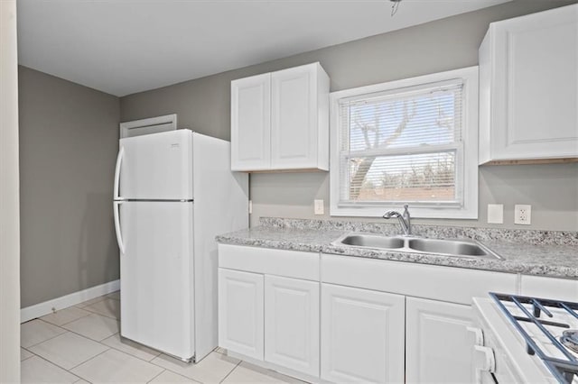 kitchen featuring light tile patterned floors, white appliances, white cabinetry, and sink