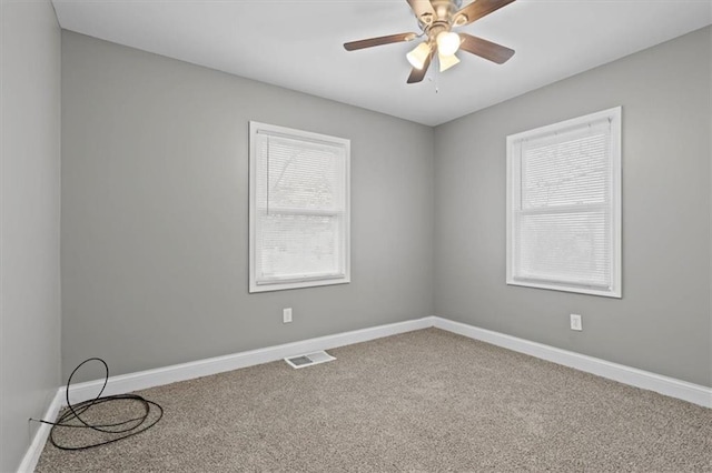 spare room with carpet floors and ceiling fan