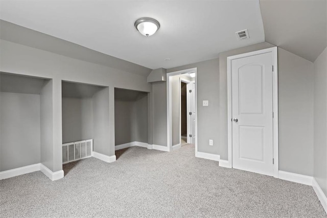 additional living space with light colored carpet and lofted ceiling