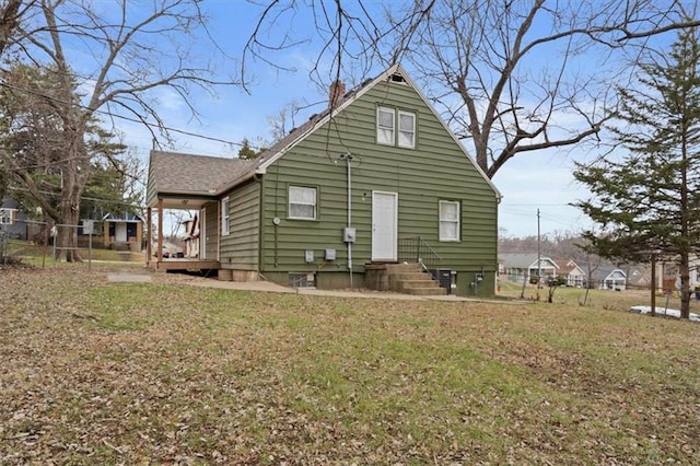 rear view of property with a lawn