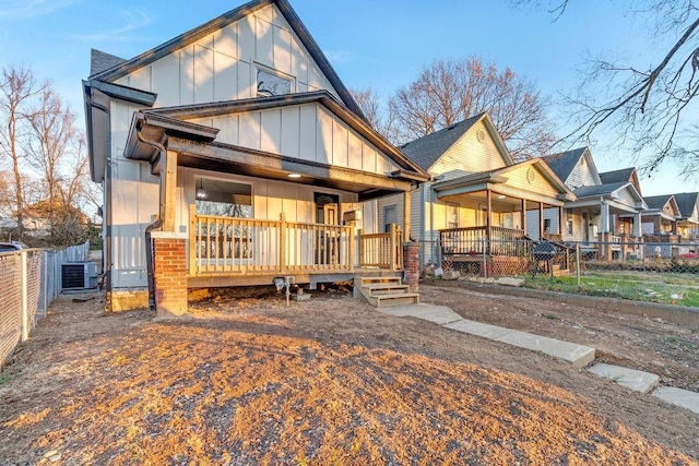 rear view of house with covered porch and central air condition unit