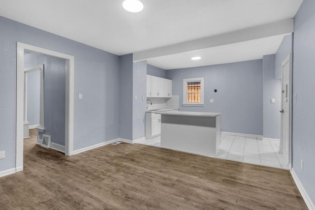 empty room with light wood-type flooring and sink