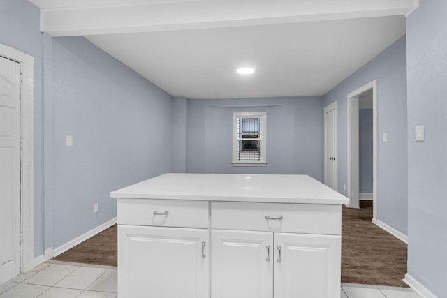 kitchen featuring white cabinetry, a kitchen island, and light tile patterned floors