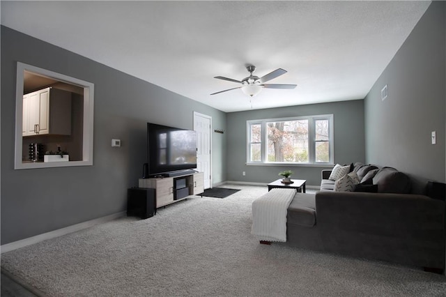 carpeted living area with a ceiling fan, visible vents, and baseboards