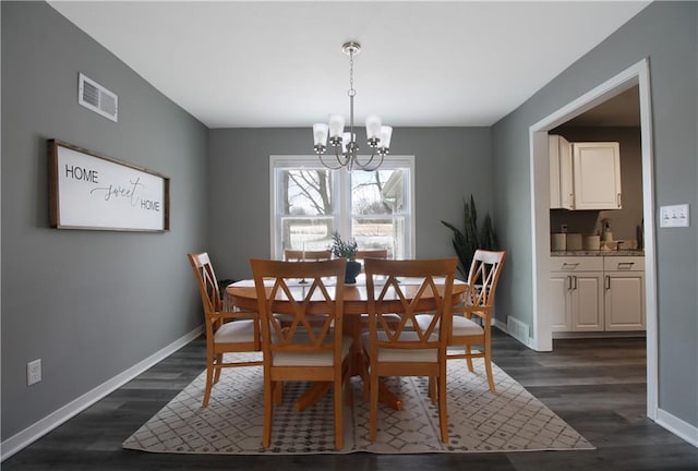 dining room featuring dark wood-style floors, an inviting chandelier, visible vents, and baseboards