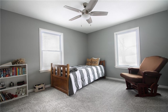 carpeted bedroom with a ceiling fan and baseboards