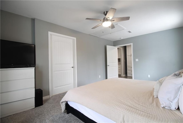 bedroom with carpet floors, attic access, visible vents, and a ceiling fan