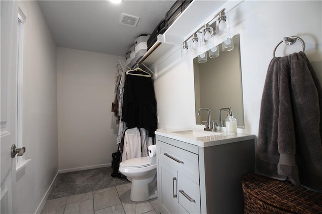 bathroom with toilet, baseboards, visible vents, and vanity