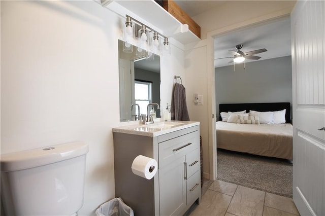 ensuite bathroom featuring toilet, vanity, a ceiling fan, and connected bathroom