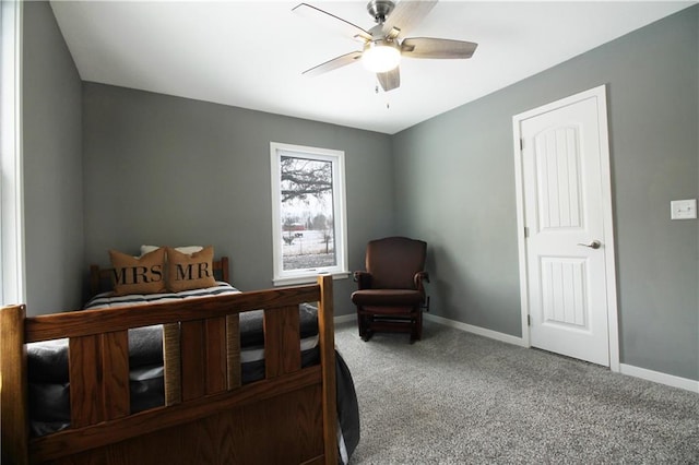 bedroom with ceiling fan, baseboards, and carpet flooring