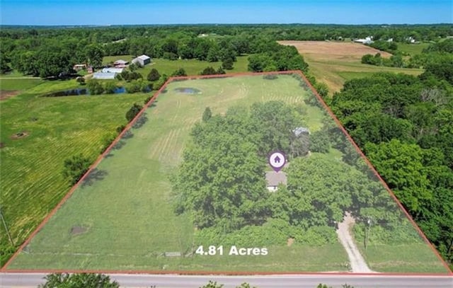 birds eye view of property with a rural view