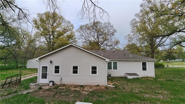 back of house with a yard and fence