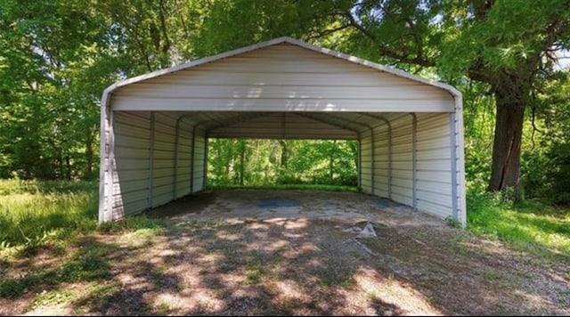 view of parking / parking lot featuring driveway and a carport