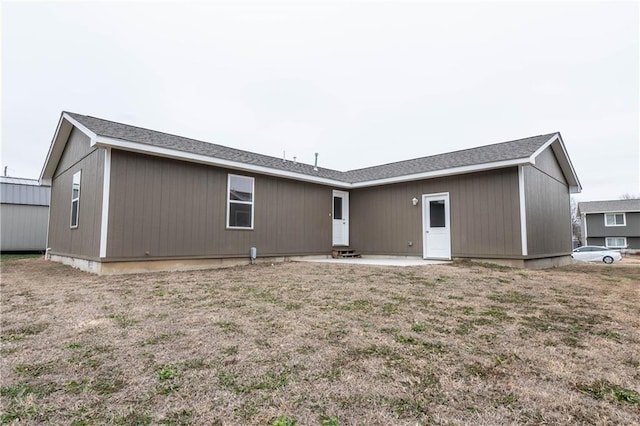 back of house with a patio area and a lawn