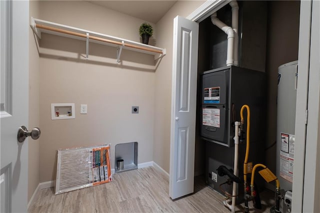 laundry room with washer hookup, electric dryer hookup, water heater, and light hardwood / wood-style flooring