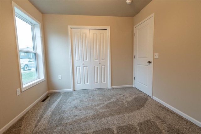 unfurnished bedroom featuring a closet and carpet floors