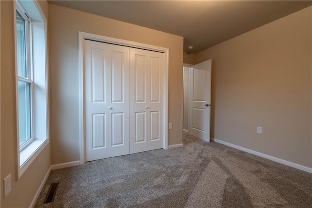 unfurnished bedroom with carpet and a closet