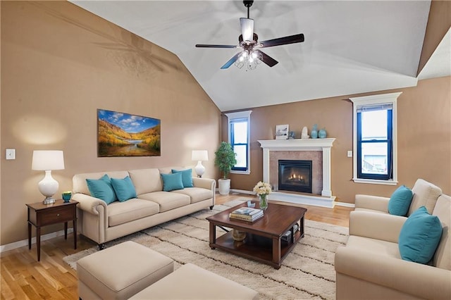 living room featuring lofted ceiling, a wealth of natural light, and light hardwood / wood-style flooring