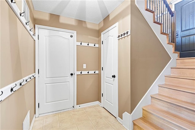 entryway featuring a textured ceiling