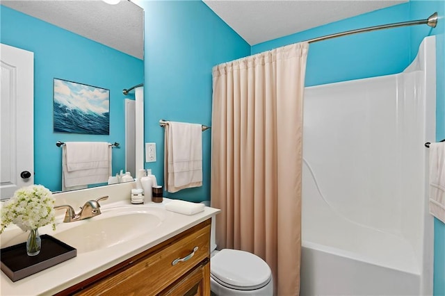 full bathroom featuring shower / bath combo, toilet, a textured ceiling, and vanity