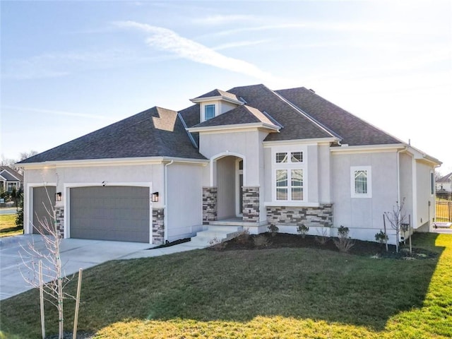 view of front of house with a front yard and a garage