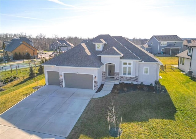 view of front of property featuring a front yard and a garage