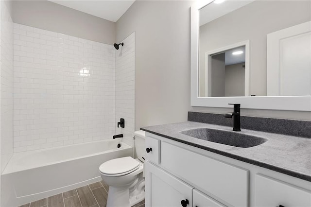 bathroom featuring shower / bathtub combination, toilet, vanity, and wood tiled floor