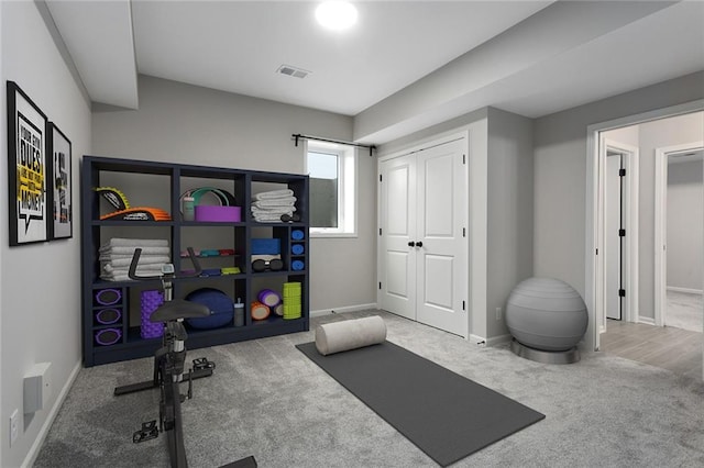 workout area featuring visible vents, baseboards, and carpet