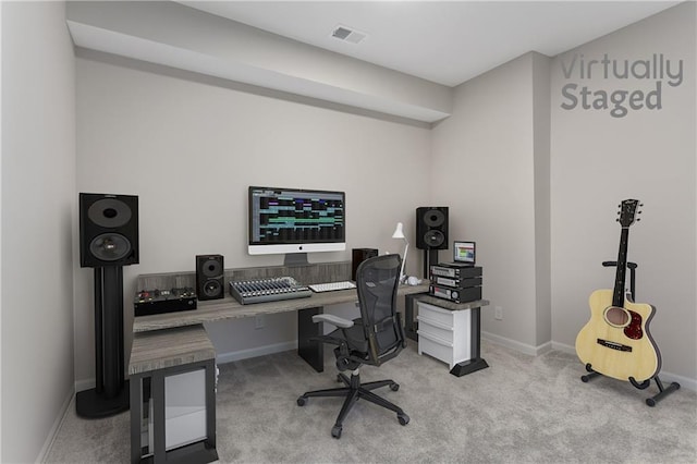 carpeted office space featuring visible vents and baseboards