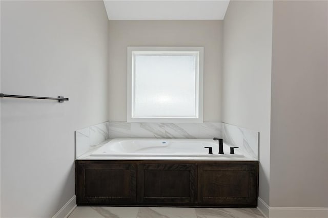 full bathroom featuring a bath and marble finish floor