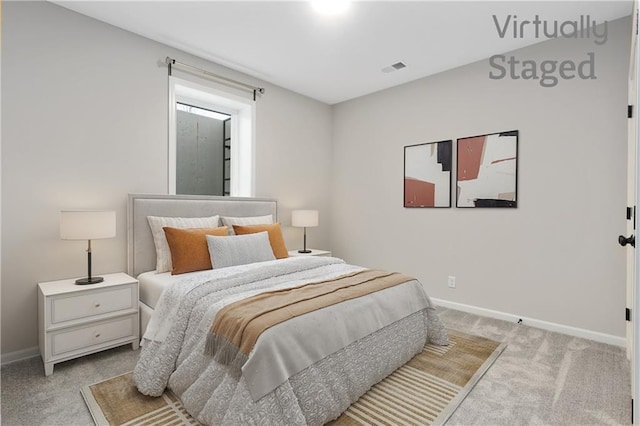 bedroom with baseboards and light carpet