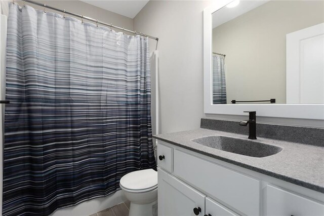 bathroom featuring toilet, a shower with curtain, and vanity