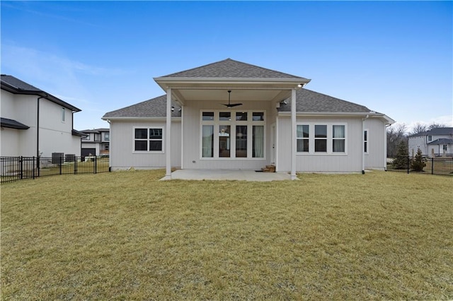 back of property with a ceiling fan, a yard, and a patio area