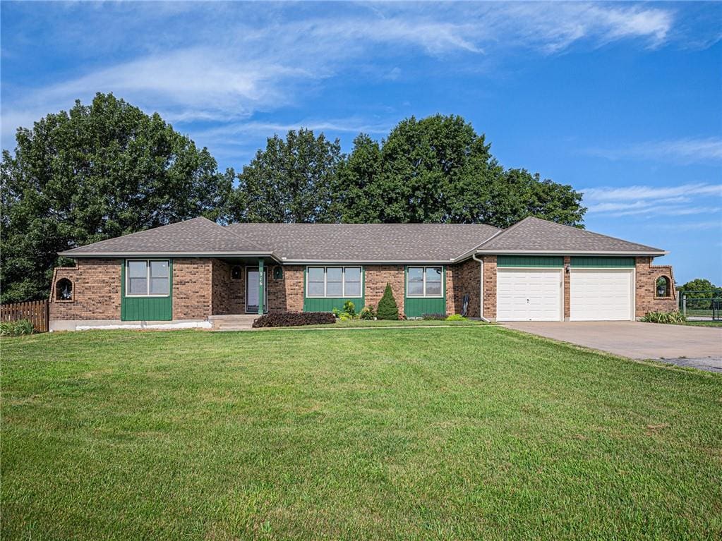 ranch-style house with a front yard and a garage