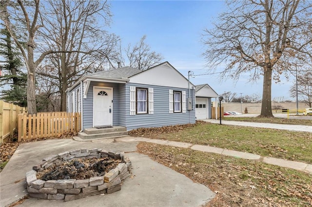 bungalow-style house featuring a front yard and a garage